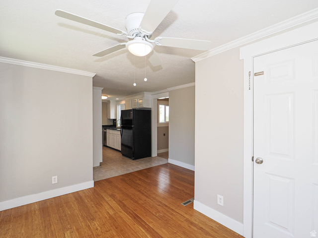 154 East 3000th Street South Bountiful, UT 84010 - Photo 13 of 37 Bright interior space with wood-finish flooring, a ceiling fan with integrated lighting, and a white paneled door