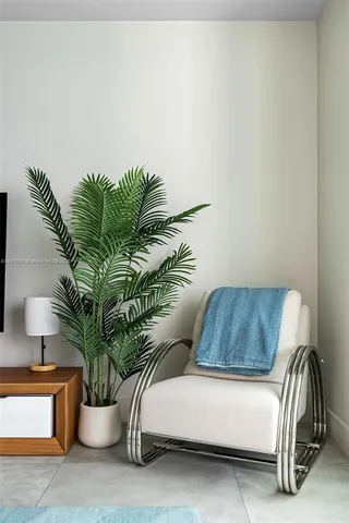 a living room with furniture and a potted plant