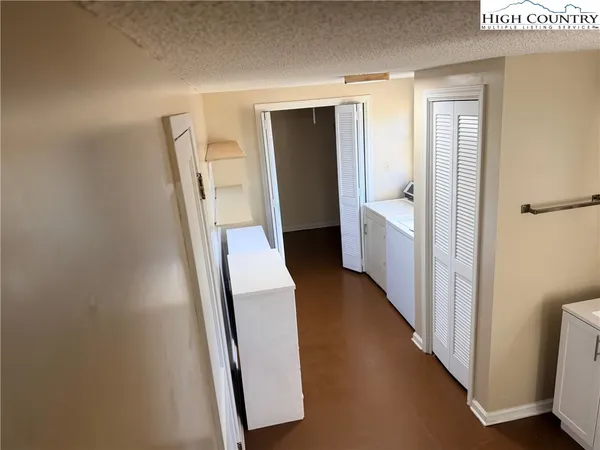 a view of hallway with stairs and wooden floor