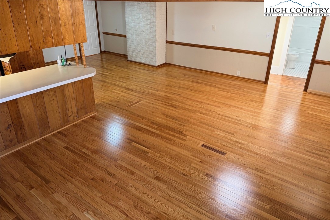 226 White Plains Road Roaring River, NC 28669 - Photo 14 of 39 a view of a room with wooden floor and staircase