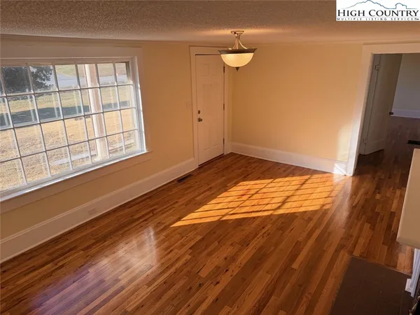 a view of an empty room and a window