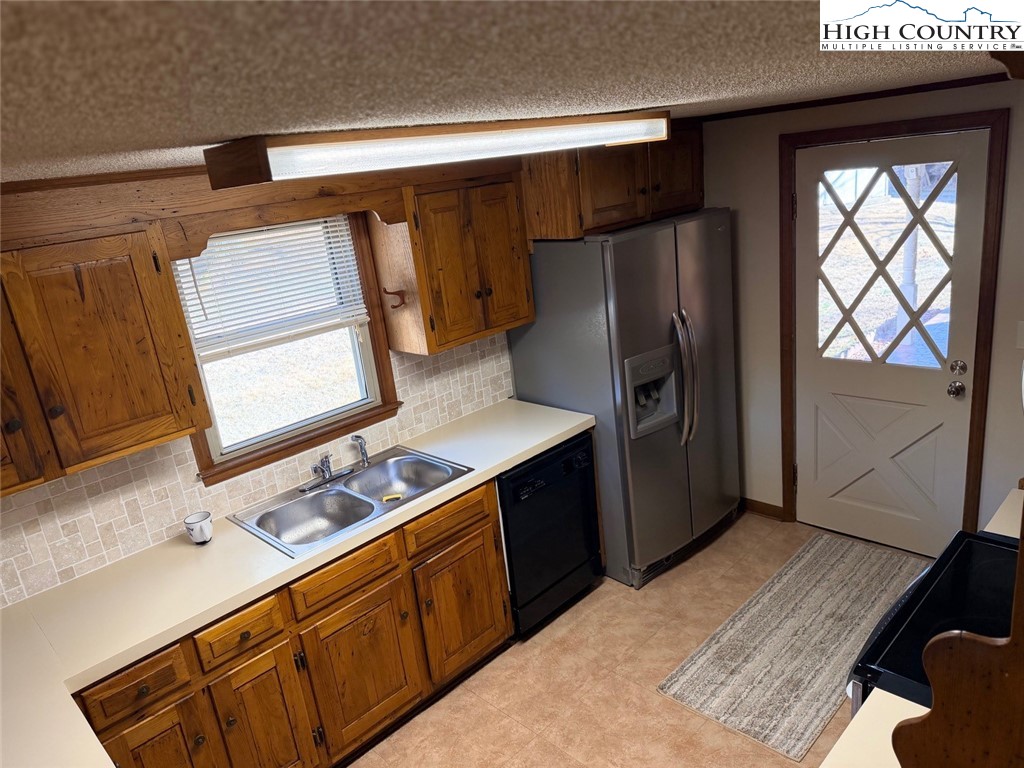 226 White Plains Road Roaring River, NC 28669 - Photo 2 of 39 a kitchen with stainless steel appliances granite countertop a refrigerator and a sink