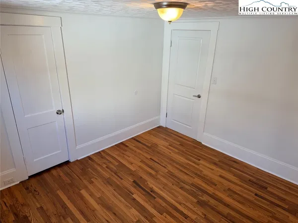 a view of room with wooden floor