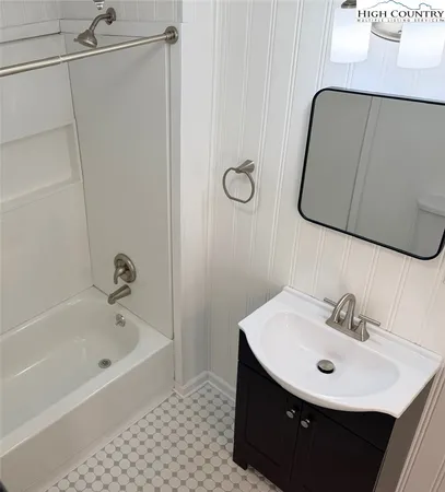 a bathroom with a sink a bathtub and a mirror