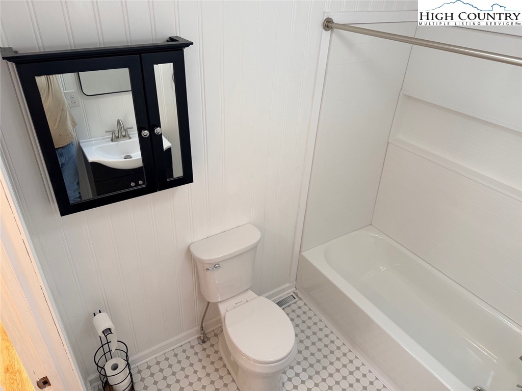 226 White Plains Road Roaring River, NC 28669 - Photo 27 of 39 a white toilet sitting next to a bath tub