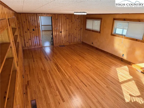 a view of a room with wooden floor