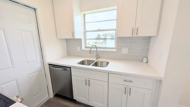 a kitchen with a sink and cabinets