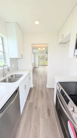 a kitchen with sink and cabinets