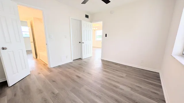 a view of a hallway with wooden floor