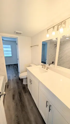 a bathroom with a double vanity sink and mirror