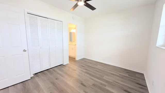 a view of a room with wooden floor and white walls