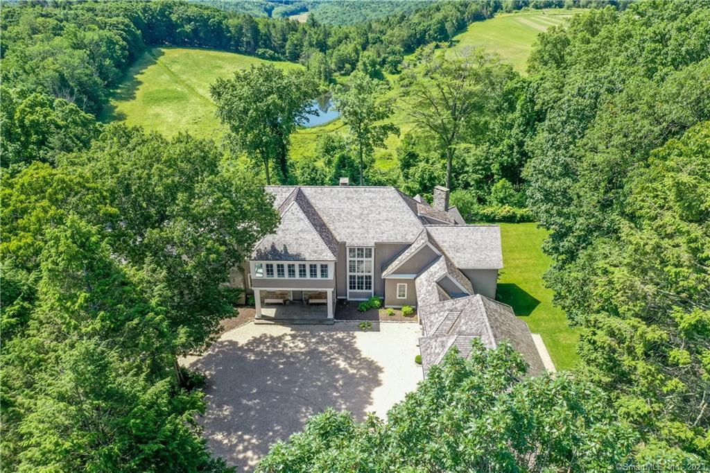 an aerial view of a house with a big yard