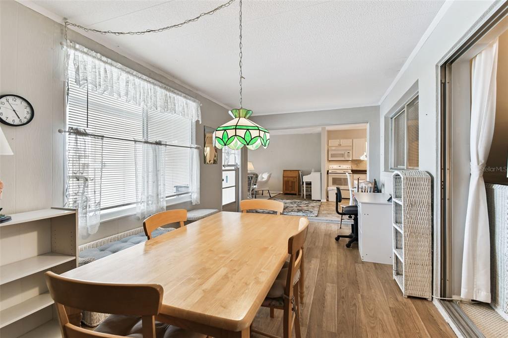 250 Rosery Road Northwest, Unit 333 Largo, FL 33770 - Photo 12 of 63 a view of a dining room with furniture window and wooden floor