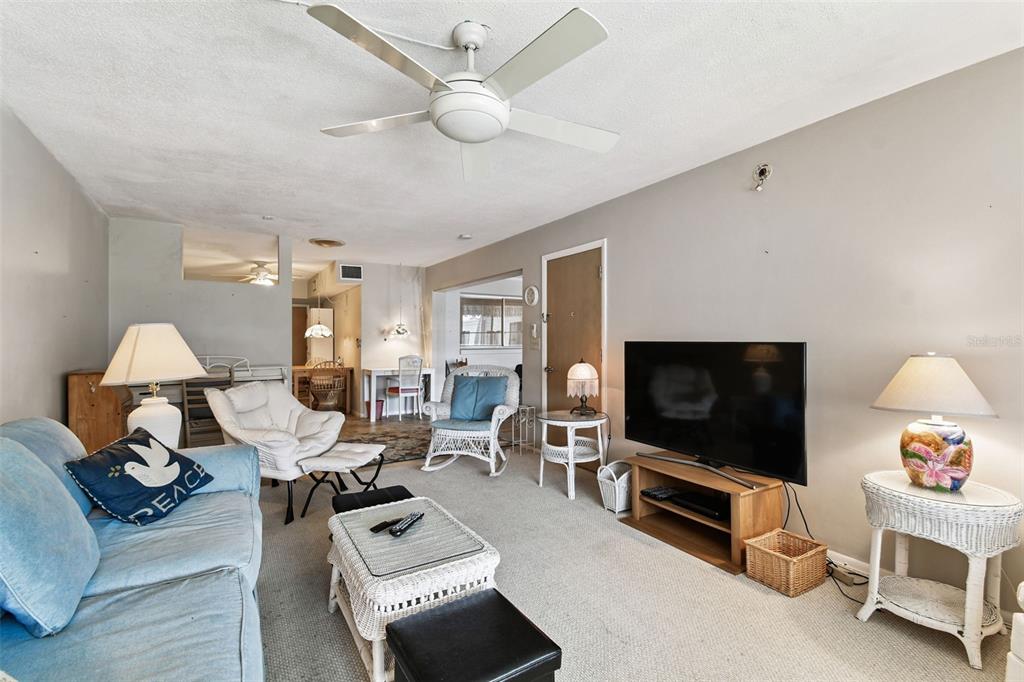 250 Rosery Road Northwest, Unit 333 Largo, FL 33770 - Photo 17 of 63 a living room with furniture and a flat screen tv