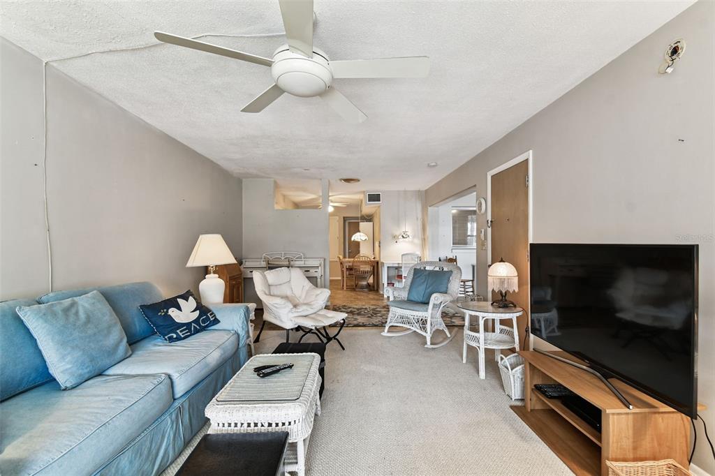 250 Rosery Road Northwest, Unit 333 Largo, FL 33770 - Photo 18 of 63 a living room with furniture and a flat screen tv