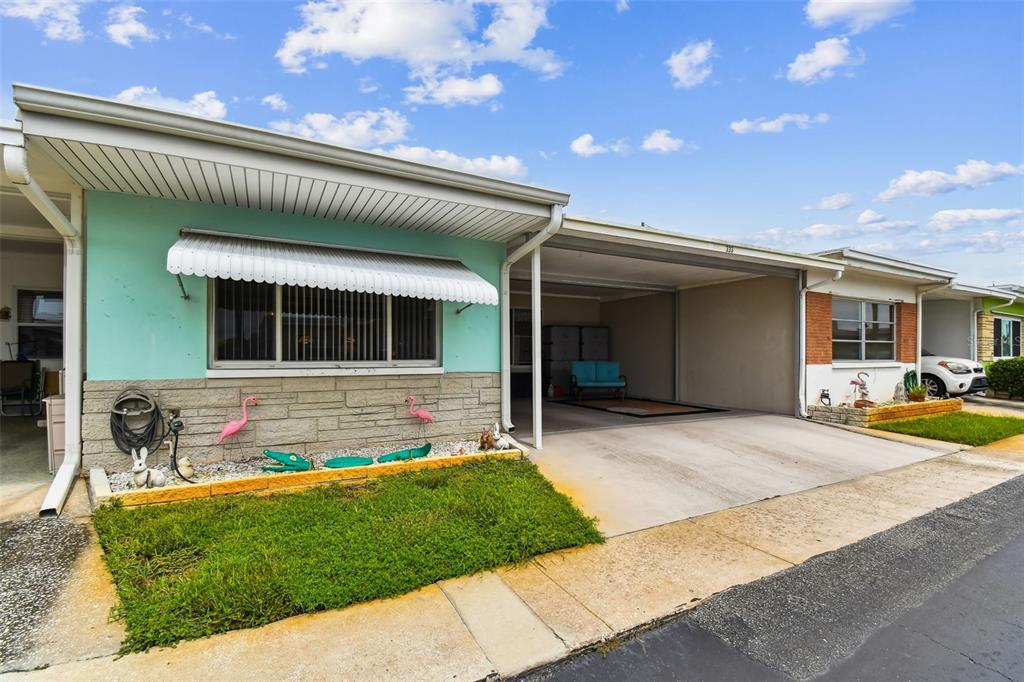 250 Rosery Road Northwest, Unit 333 Largo, FL 33770 - Photo 2 of 63 a front view of a house with a garden