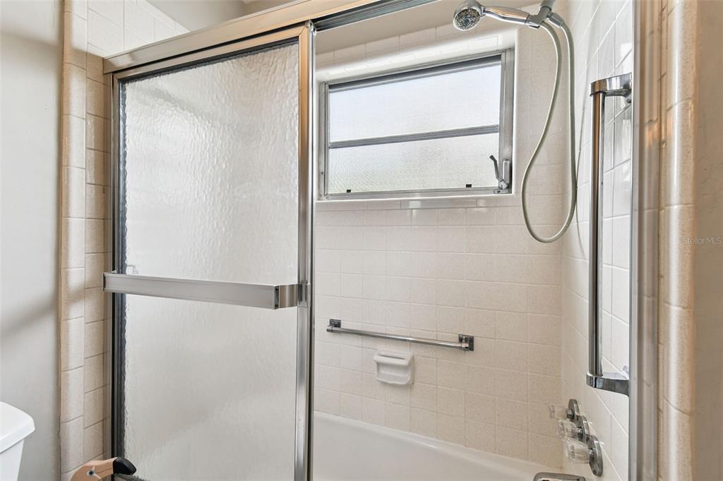 250 Rosery Road Northwest, Unit 333 Largo, FL 33770 - Photo 31 of 63 a bathroom with a glass shower door