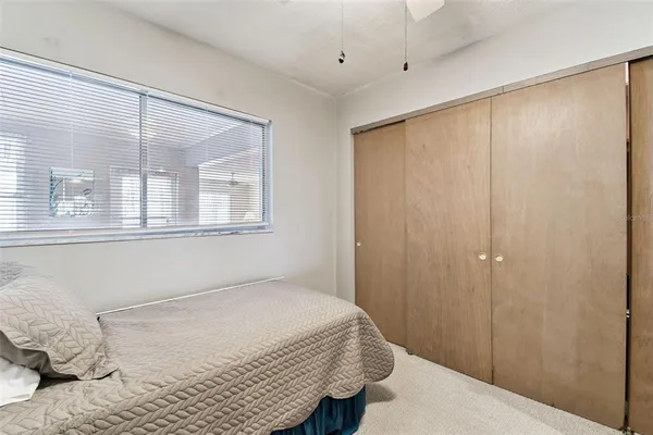 a spacious bedroom with a bed and a chandelier