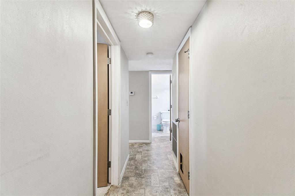250 Rosery Road Northwest, Unit 333 Largo, FL 33770 - Photo 35 of 63 a view of a hallway with wooden shelves