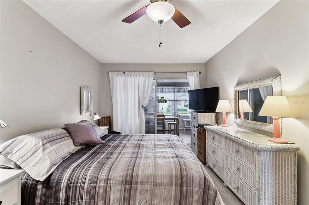 250 Rosery Road Northwest, Unit 333 Largo, FL 33770 - Photo 37 of 63 a bedroom with a bed and a flat screen tv