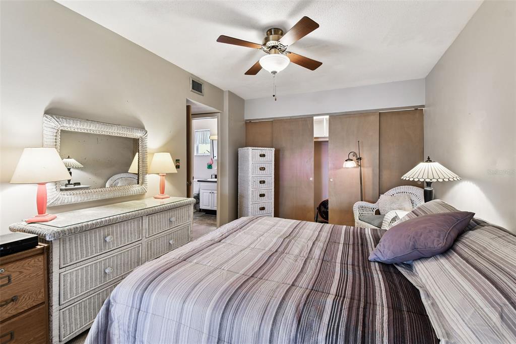 250 Rosery Road Northwest, Unit 333 Largo, FL 33770 - Photo 38 of 63 a bedroom with a large bed and a chandelier