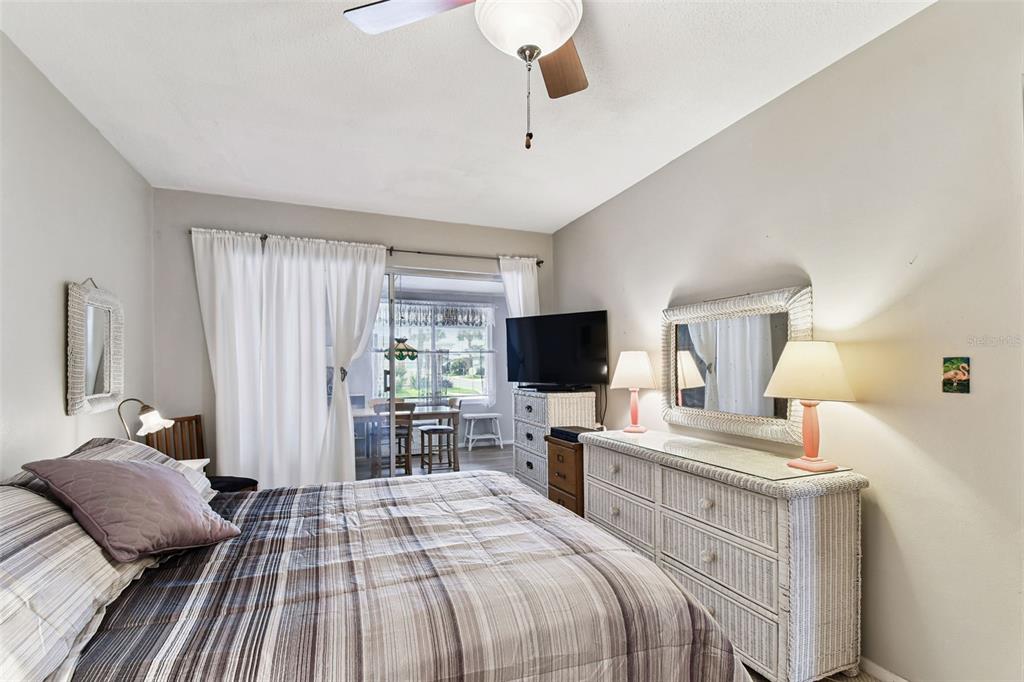 250 Rosery Road Northwest, Unit 333 Largo, FL 33770 - Photo 39 of 63 a bedroom with a bed and a flat screen tv