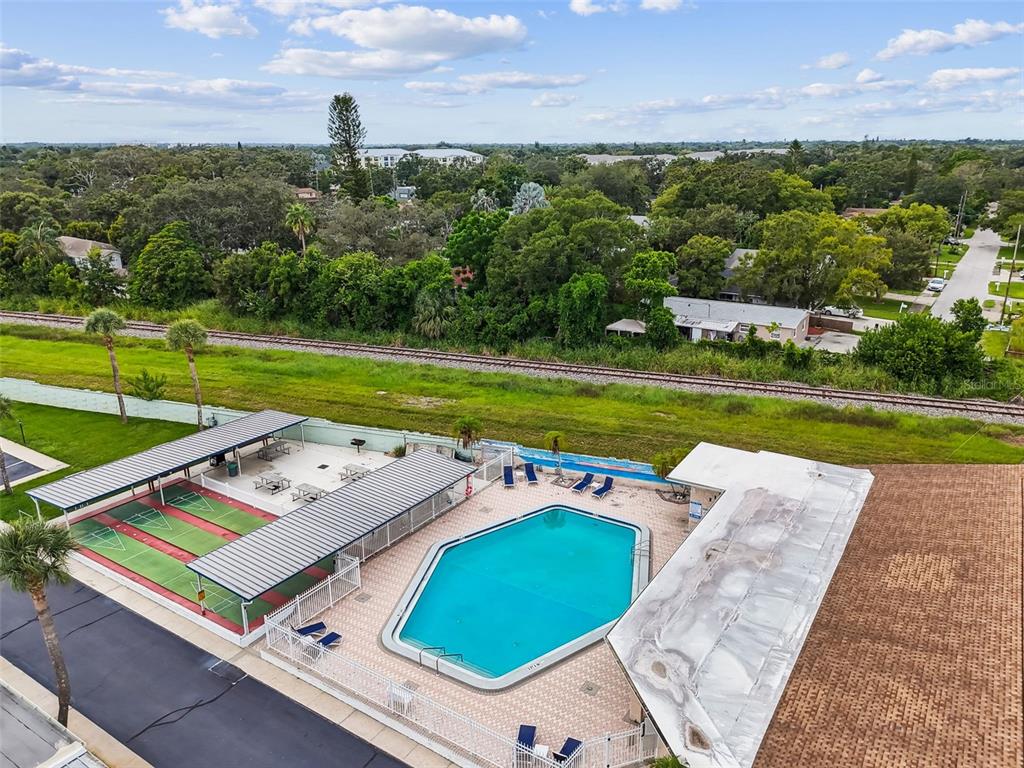 250 Rosery Road Northwest, Unit 333 Largo, FL 33770 - Photo 44 of 63 a view of a big yard with an outdoor space and seating