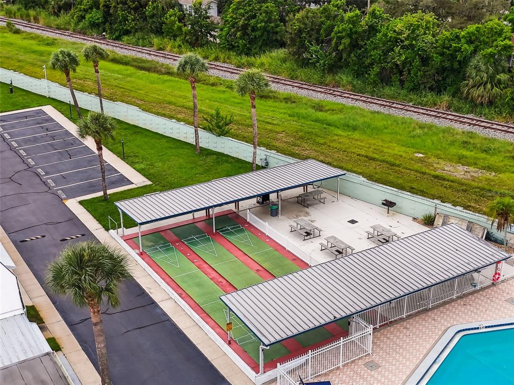 250 Rosery Road Northwest, Unit 333 Largo, FL 33770 - Photo 45 of 63 a view of a patio with table and chairs and wooden fence