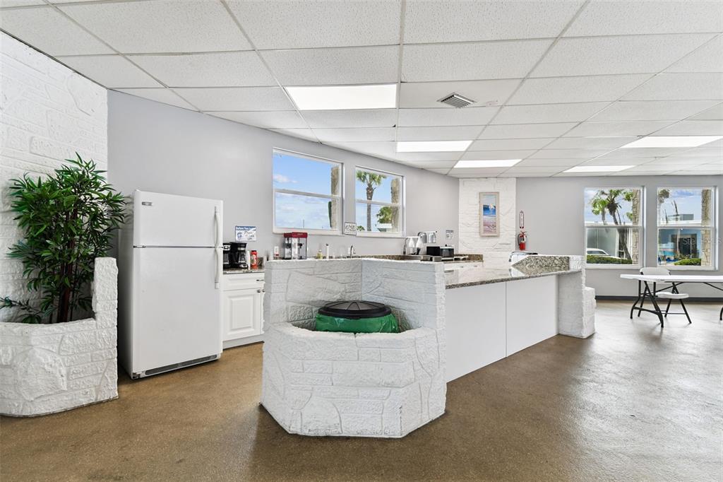 250 Rosery Road Northwest, Unit 333 Largo, FL 33770 - Photo 55 of 63 a kitchen with a white refrigerator a stove a dining table and chairs