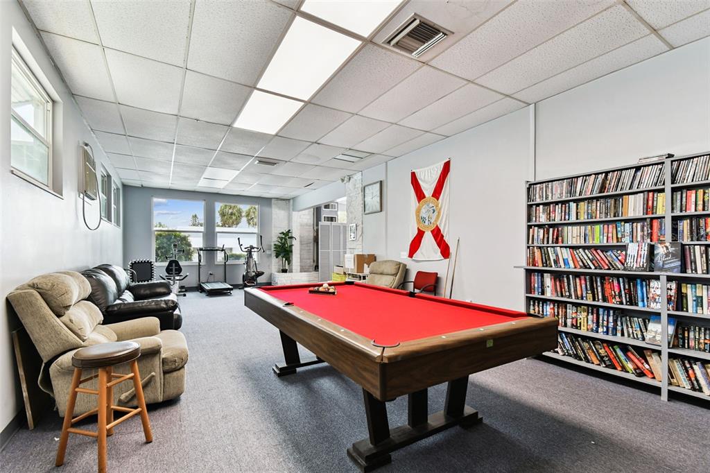 250 Rosery Road Northwest, Unit 333 Largo, FL 33770 - Photo 56 of 63 a living room with furniture and a book shelf