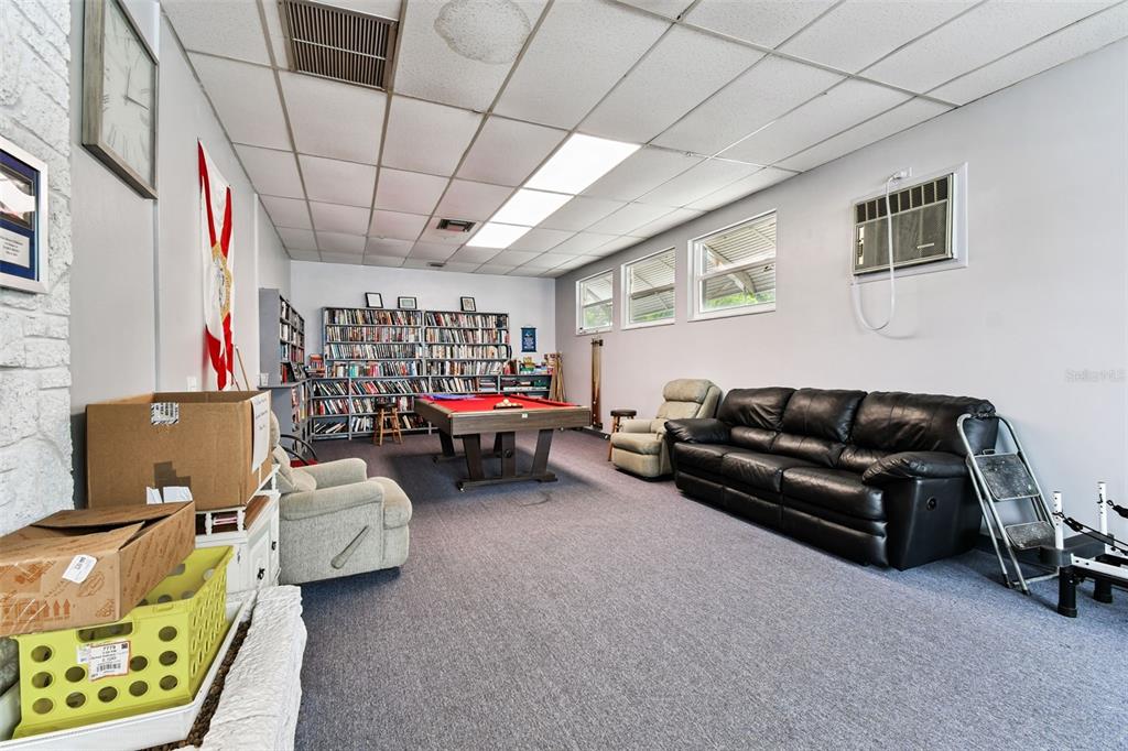 250 Rosery Road Northwest, Unit 333 Largo, FL 33770 - Photo 58 of 63 a living room with furniture and a flat screen tv