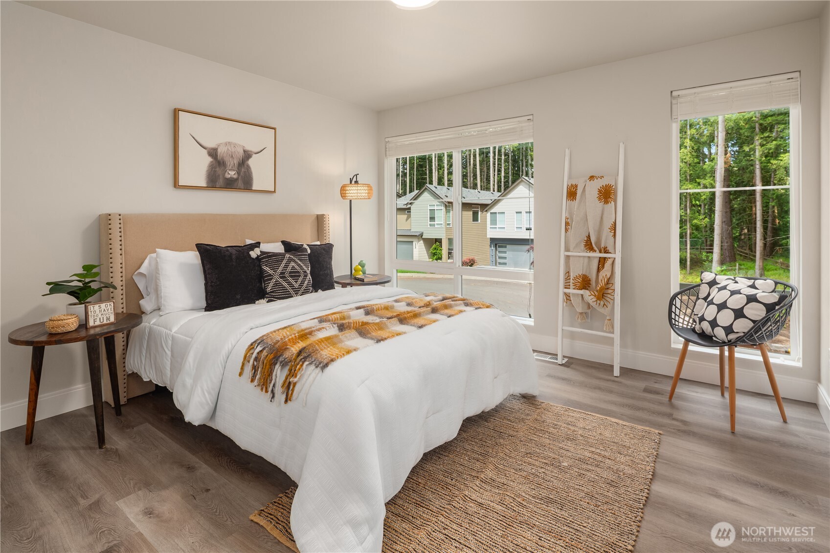 22308 17th Avenue West, Unit 12 Bothell, WA 98021 - Photo 27 of 33 a bedroom with a bed and a painting on the wall