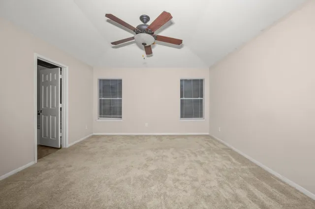 a view of room with a ceiling fan