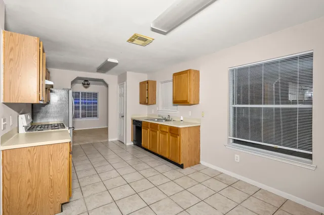 a kitchen with stainless steel appliances a sink stove and cabinets