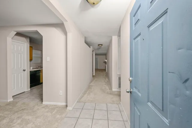 a view of a hallway with closet and livingroom