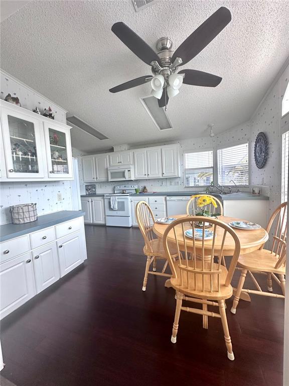 1100 South Belcher Road, Unit 406 Largo, FL 33771 - Photo 6 of 46 a view of a dining room with furniture a kitchen and chandelier