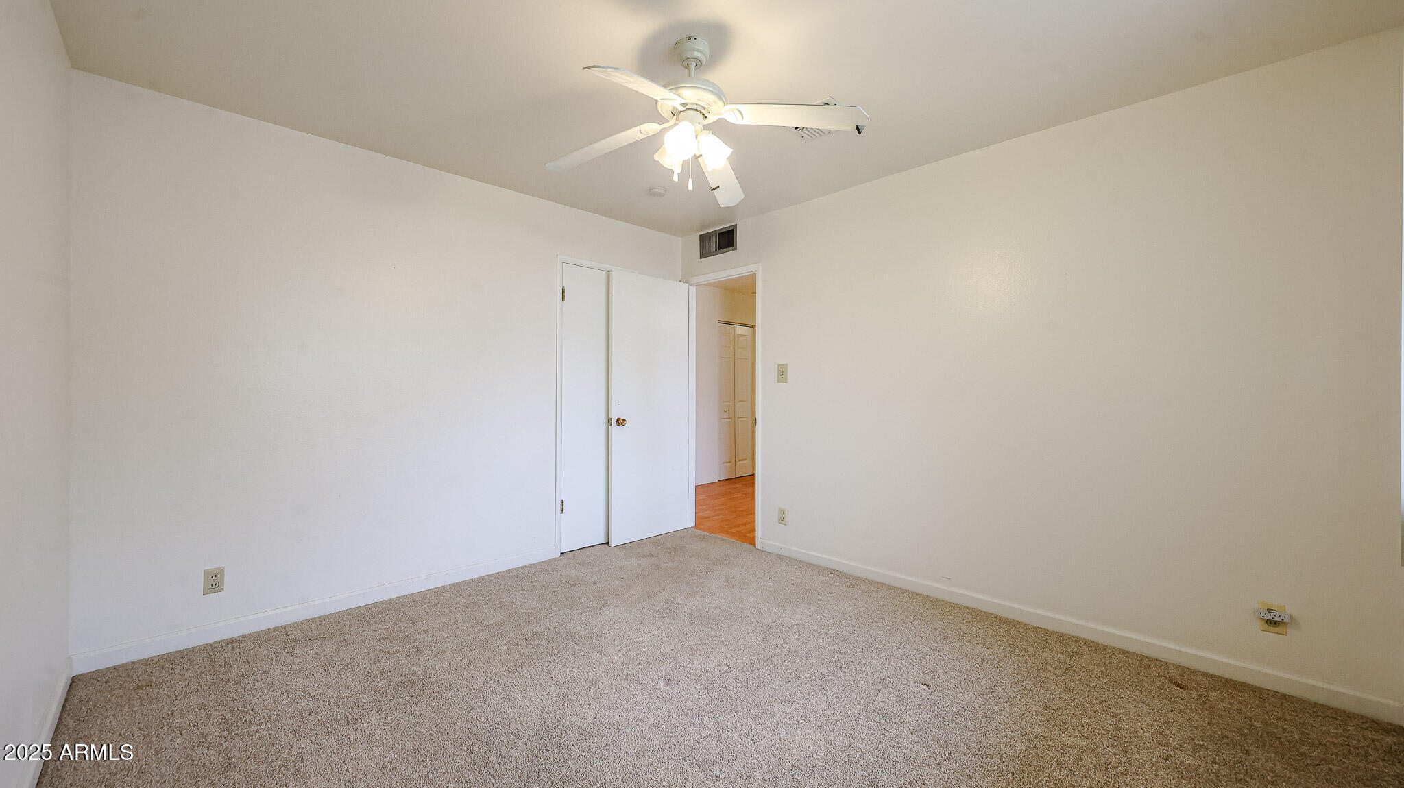11851 North Thunderbird Road Sun City, AZ 85351 - Photo 23 of 46 an empty room with a ceiling fan and a fan