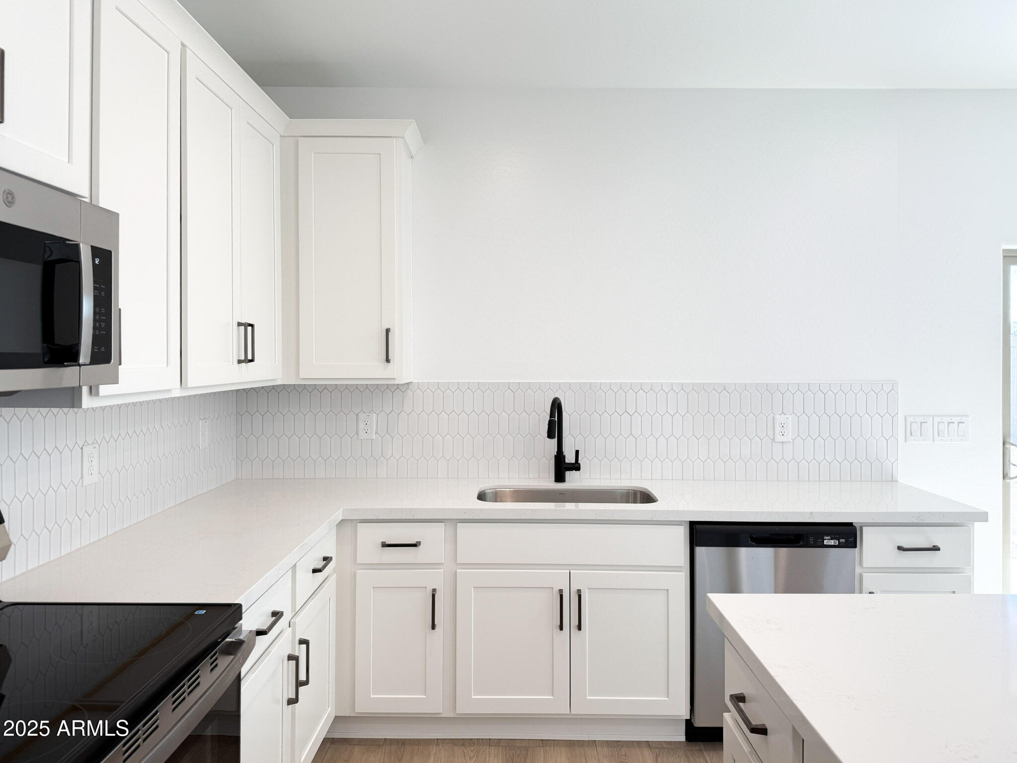 18203 La Senda Drive West Surprise, AZ 85387 - Photo 5 of 43 a kitchen with granite countertop white cabinets and white appliances