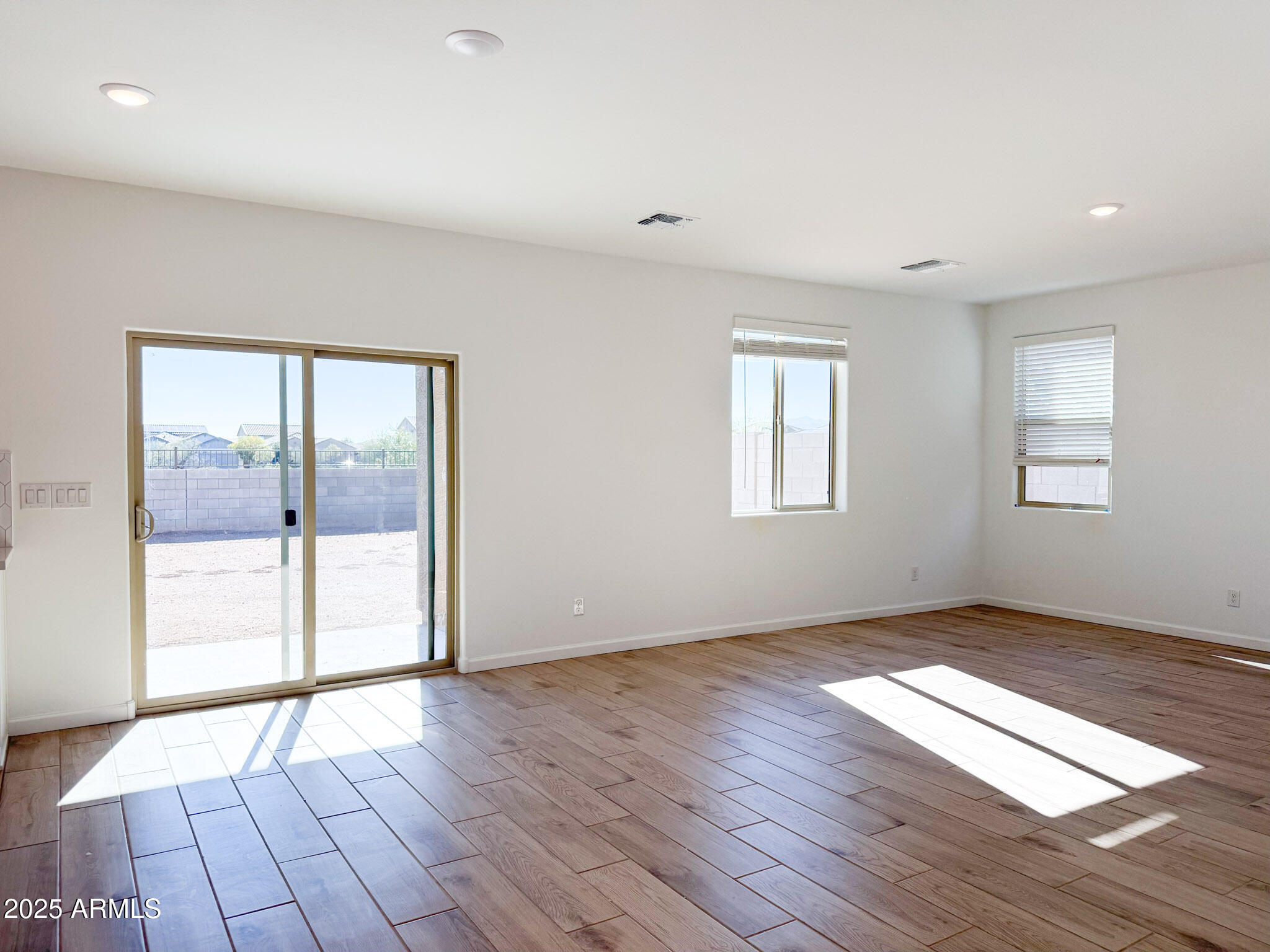18203 La Senda Drive West Surprise, AZ 85387 - Photo 8 of 43 a view of an empty room with glass door and wooden floor