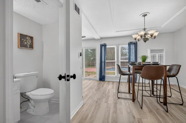a view of a dining room with furniture and wooden floor