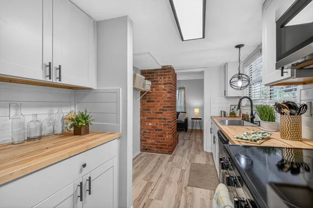 a view of a hallway with wooden floor and stairs