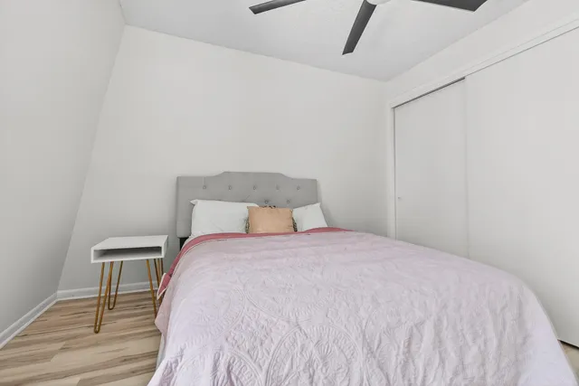 a bedroom with a bed and wooden floor