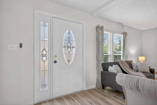 a living room with furniture a fireplace and window