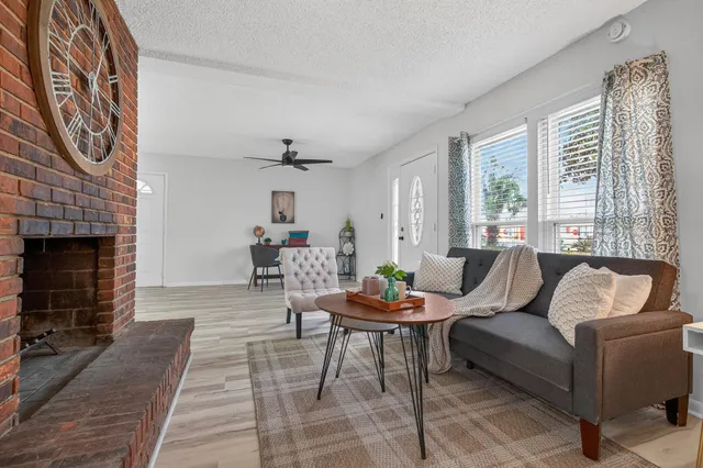 a view of a hallway with wooden floor and stairs