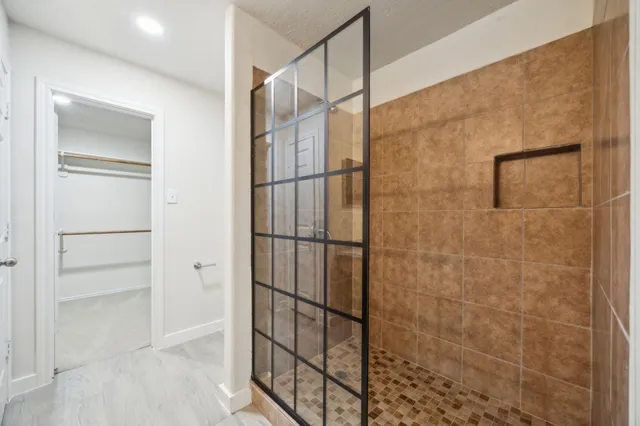 a bathroom with a glass shower door