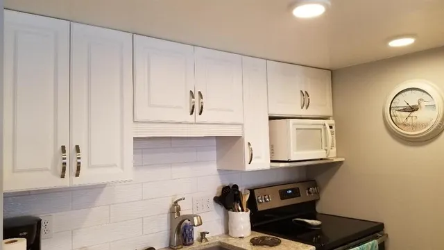 a view of kitchen cabinetry and a stove top oven