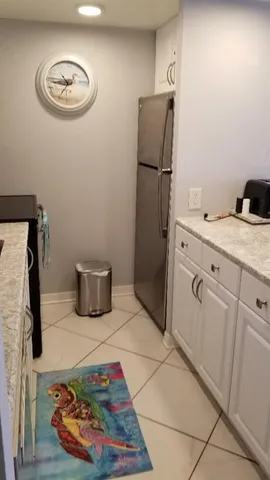 a kitchen with stainless steel appliances granite countertop a refrigerator and a stove top oven