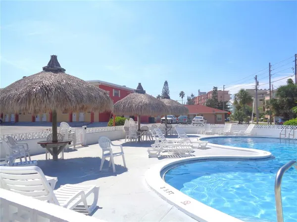 a view of swimming pool with outdoor seating and plants