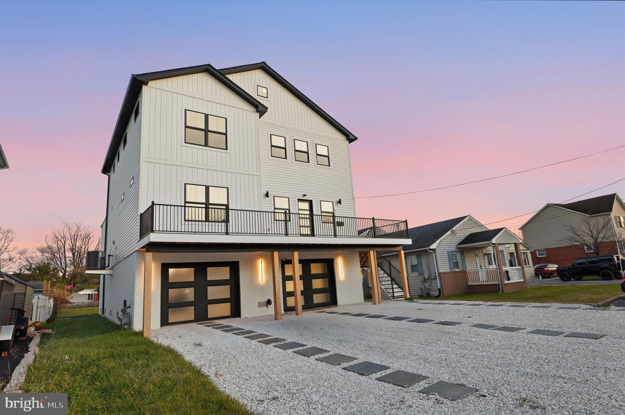 a front view of a house with a garden and parking