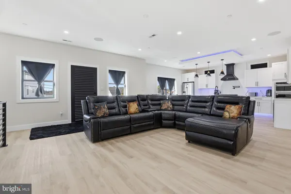 a kitchen with stainless steel appliances a sink a stove and a wooden floors